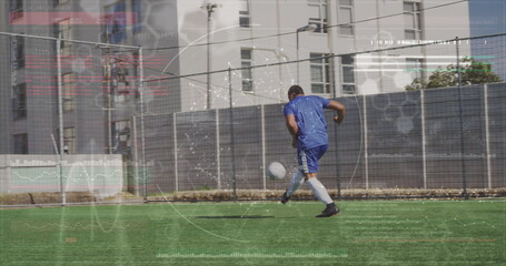 Image of interface processing data over african american male footballer kicking ball on pitch