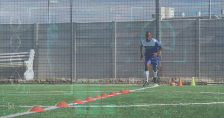 Image of interface processing data over biracial male footballer training running on pitch