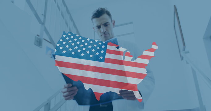 Image of usa map with flag over caucasian female and male doctors talking on corridor - Powered by Adobe