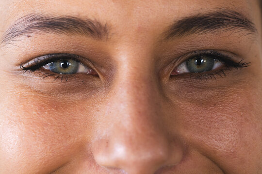 Close-up of a young biracial woman's eyes, with copy space