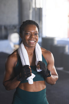 Biracial woman takes a break at the gym, with copy space
