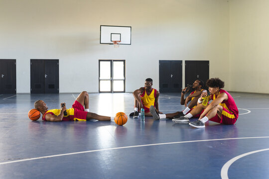 Diverse basketball team takes a break in the gym