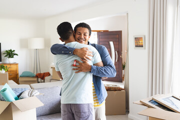 Gay couple embracing in a new home
