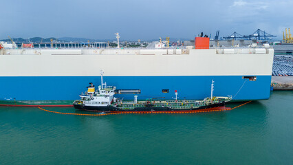 Oil ship refueling to Cargo ship at dock, Refueling at sea Oil products ship fuelling a large Bulk...