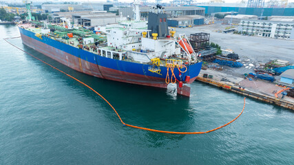 Naklejka premium Oil tanker ship at dry dock concept maintenance service. working at dry dock. Insurance and Maintenance Crude tanker Ship concept. Freight Forwarding Service maintenance Insurance