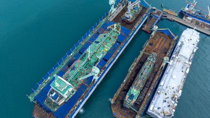 Oil tanker ship at dry dock concept maintenance service. working at dry dock. Insurance and...
