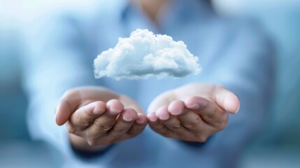Hands holding a cloud symbol, representing cloud computing, online storage, and internet technology concepts in a blurred background.