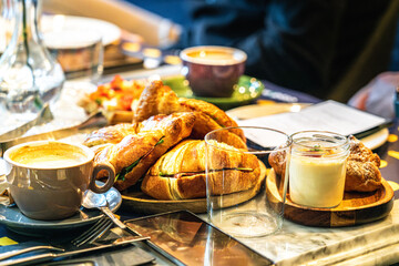 Breakfast hotel restaurant table. Morning meeting conference. Sandwich with Parma ham. Coffee cup.