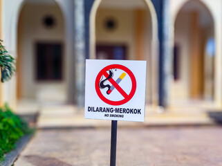 warning sign with DILARANG MEROKOK symbol in English NO SMOKING. in general public areas