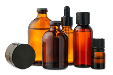 Amber Glass Bottles of Essential Oils and Cream Isolated on White Background