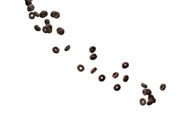 Chocolate rings cereal spill out into a bowl. Breakfast.