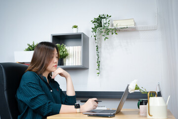 asian woman use laptop for working her business from home