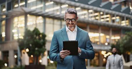Business, mature man and tablet outdoor for communication, research and typing email on website....