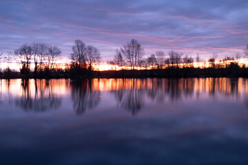 Nightscape photo of Adour French river after blazing red sunset