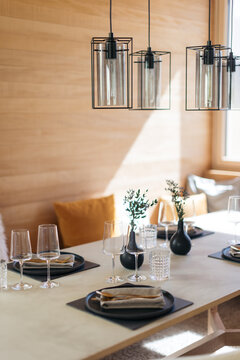 Elegant table setting with modern decor and wine glasses