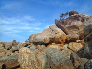 Granite stones and blue sky at the Turun Aban beach, Bangka Island