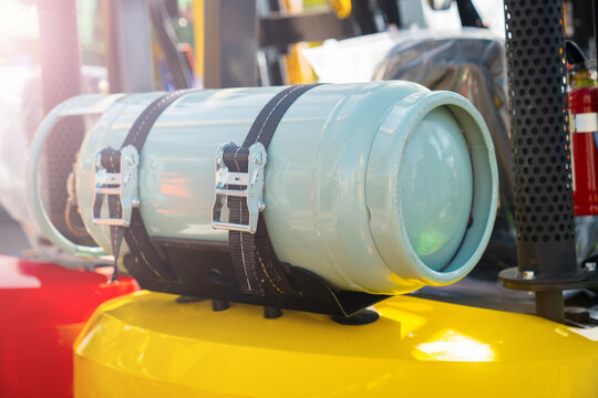 Gas cylinder on the forklift LPG gas for forklift trucks Equipment for the warehouse  Production and use LPG gas - Powered by Adobe