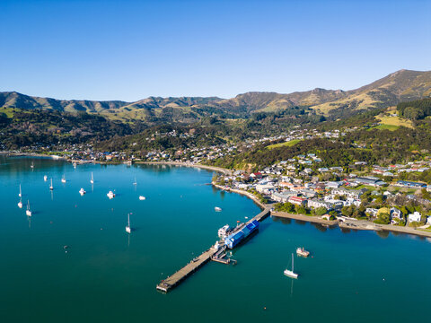 Akaroa, New Zealand: Aerial drone view of the stunning Akaroa idyllic village in the Banks Peninsula in the Christchurch region of Canter bury in New Zealand south island on a sunny day.