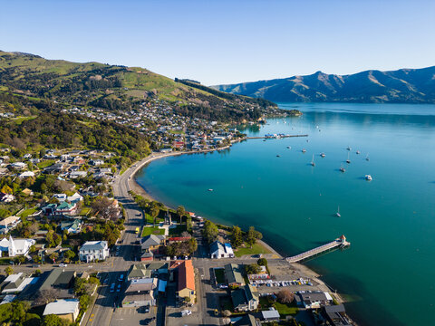 Akaroa, New Zealand: Aerial drone view of the stunning Akaroa idyllic village in the Banks Peninsula in the Christchurch region of Canter bury in New Zealand south island on a sunny day.