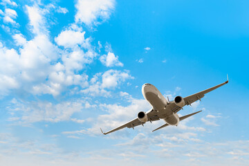 White passenger airplane flying in the sky amazing clouds in the background - Travel by air transport
