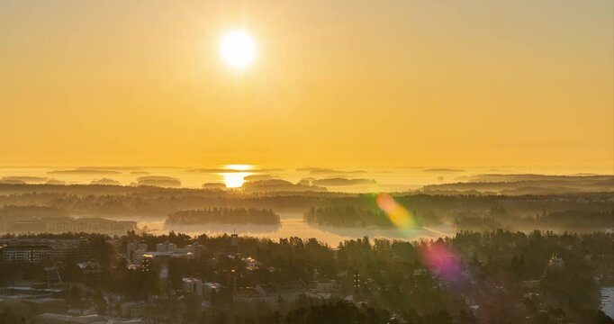 Timelapse of a hazy sun moving over Kulosaari and snowy archipelago of Helsinki