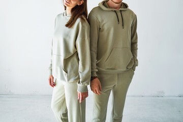 Man and woman in comfortable green hoodies and pants