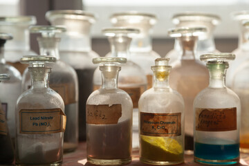 Chemical bottles arranged in a school chemistry lab, ready for experiments and scientific exploration by students.