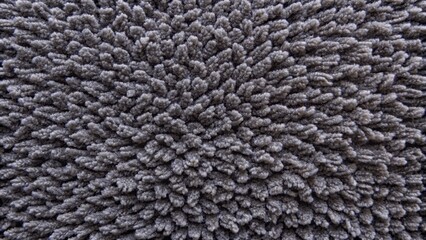 Luxurious dark grey terry cloth carpet with soft fluffy texture, perfect for modern interior decoration, displayed in a close-up top view.