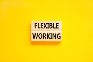 Flexible working symbol. Concept words Flexible working on beautiful wooden block. Beautiful yellow paper background. Business flexible working concept. Copy space.
