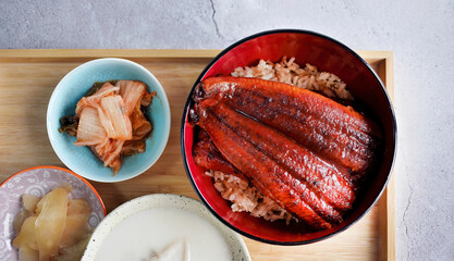 Unadon, charcoal grilled freshwater eel Unagi kabayaki with teriyaki sauce over rice, traditional Japanese cuisine, Rice topped with broiled eel in wood urushi lacquerware