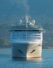 Cruiseship cruise ship liner Pacific World arrival into Vancouver, BC port with scenic mountain...