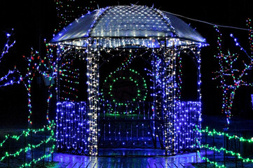 A gazebo decorated with blue LED ribbon in a city park