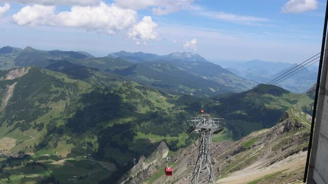 Cable car ascending to mountain peak in Swiss mountains, establisher