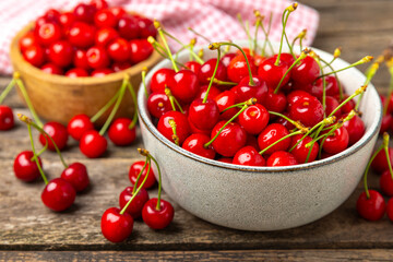 Cherries. Fresh ripe cherries with leaves on a textured wooden background. Fresh sweet organic cherry pile. Berries and fruits. Vegan. Healthy eating. Place for text. Copy space