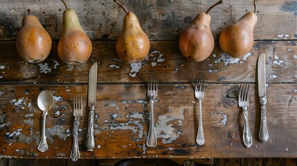 An antique timber table with four pears and old flatware