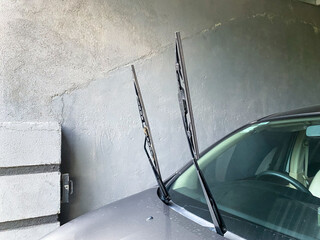 raised up wipers on parked car on a hot weather