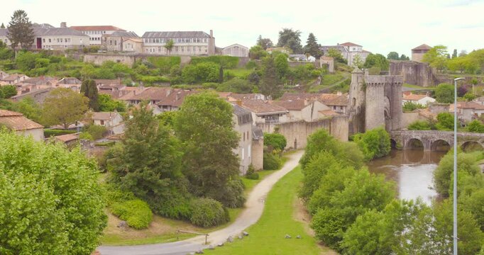 Fortified Town With Ch&acirc;teau de Parthenay Over River Thouet In Western France. Aerial Wide Shot