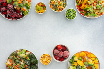 Preparing fresh vegetables in summer for winter, various frozen vegetables and berries in plates on...