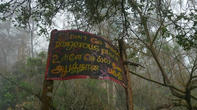 Dangerous place signage at the entrance of forest in Guna Cave in Kodaikanal