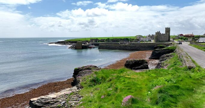 Ireland Epic locations Slade Fishing Harbour on the Hook Head Peninsula with Slade Castle on a summer morning