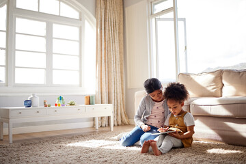 Girl, children and playing with tablet on floor for online games, elearning or educational video in home. Friends, people or digital tech on carpet for watching movies, fun cartoons or bonding on mat