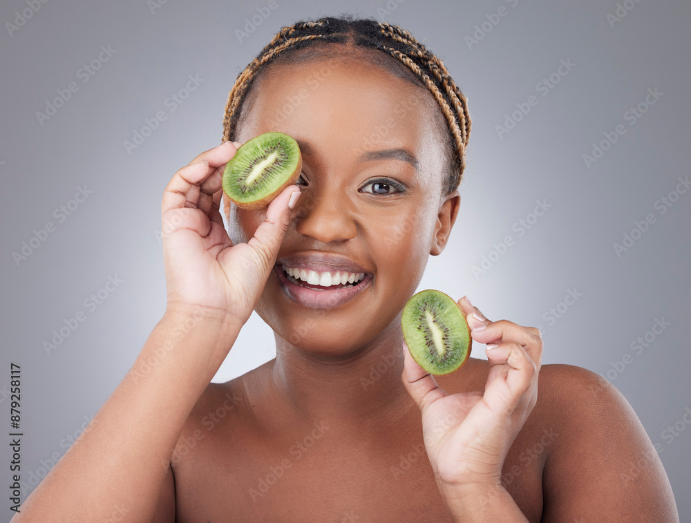 Canvas Prints Black woman, kiwi and portrait with smile in studio with diet, nutrition and detox for gut health by white background. Model, girl person with fruit to cover eye, benefits and vegan to lose weight