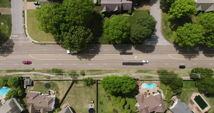 Median parking, dividing two traffic lanes. Suburban scenery seen from above.
