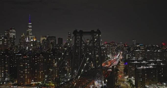 NYC New York Aerial v300 tracking flyover capturing traffic on Williamsburg Bridge and illuminated downtown cityscape of Lower East Side Manhattan at night - Shot with Inspire 3 8k - September 2023