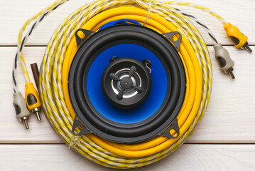 Modern car audio stereo speakers and power cable on the workbench background. Car stereo renew...