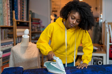 African-American girl in her sewing workshop.