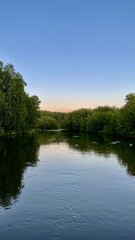 A landscape with a view of the river and the sunset