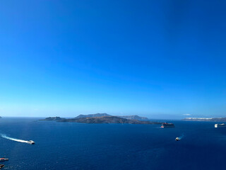 Beautiful view of the sky and sea with a moutain in the middle and some boats