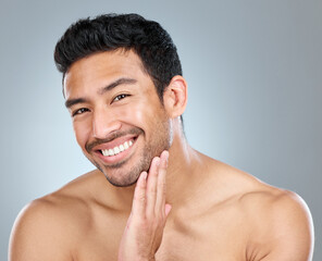 Obraz premium Beauty, portrait and smile of natural man in studio on gray background for cosmetic wellness. Dermatology, grooming and skincare with face of happy person in bathroom for hydration or hygiene