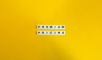 Premium Pricing Term and Concept Image. Pricing Strategy Banner. Text on Block Letter Tiles on Yellow Background. Minimal Aesthetics.